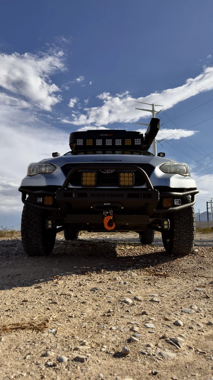 Low front view of Astro showing the Rigid Armor front bumper and auxiliary lighting